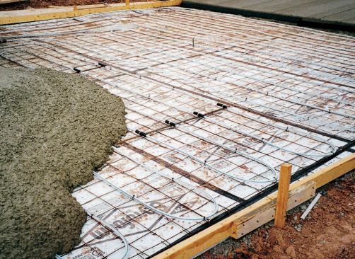 To avoid damage to the tubing, control joints should never be cut after the concrete sets. Instead, use plastic strips or a similar technique to form control joints when the concrete is placed. Sections of black closed-cell-foam pipe insulation protect the tubing against slight movement at control joints.