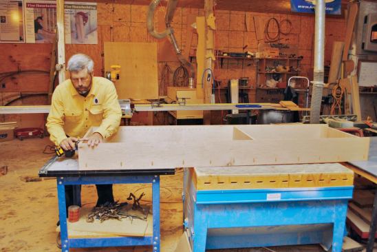 Cabinet pieces are glued and screwed together in the shop.
