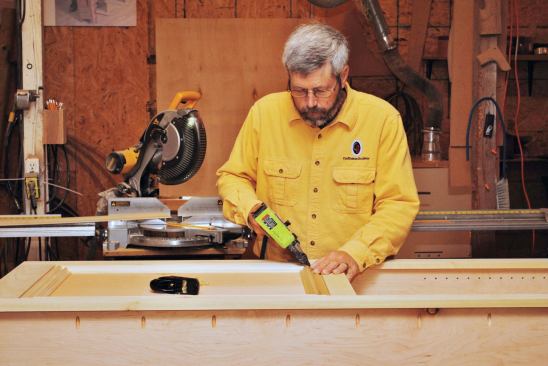 A frame of decorative molding inside the face frame completes the recessed panel on the front of the case.