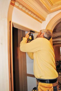 Running screws through special slotted holes in the hinge plates allows the cabinet's position to be tweaked when it has been hung.
