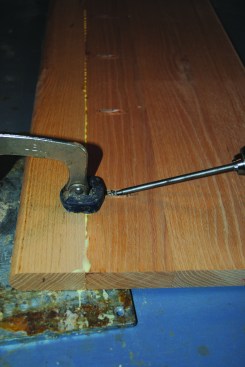 For curved-stair work, the author glues the angled pieces for the stair treads using pipe clamps. He then uses pocket screws for attaching the bullnose edging to the tread.