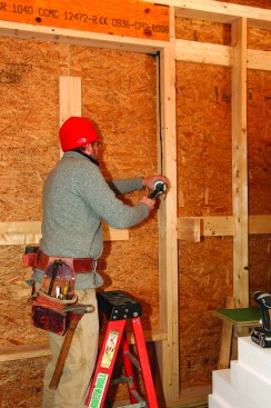 Acoustical sealant would bed the sheathing that would bridge the interior (2x4) wall and the exterior (2x6) wall around the window opening.
