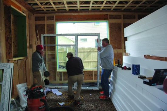 The triple-pane unit was heavy and required three people to set it into place.