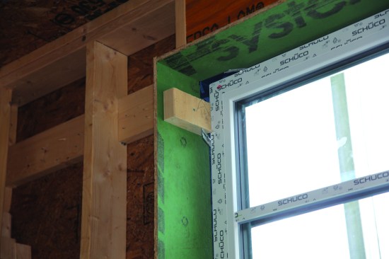 Scraps of 2-by temporarily screwed in held the window at its finished "inside-outside" location.