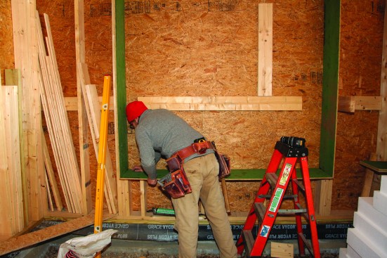Half-inch OSB Zip Wall sheathing was bedded into sealant around the perimeter of the window opening.