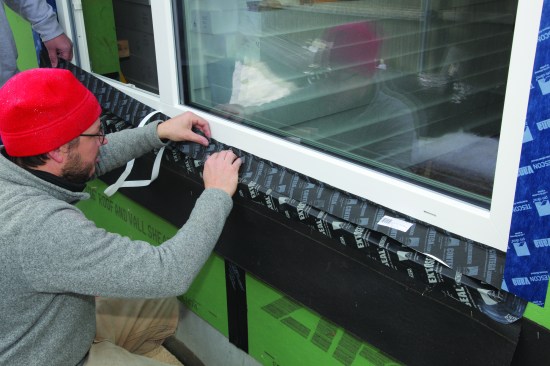 Workers sealed the window to the opening using a tape that repels water and allows vapor to pass through it.