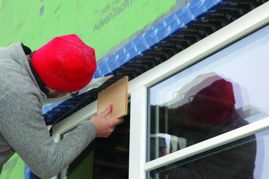 To complete the window install, the head flashing was adhered. The ends of the head flashing lapped down over the top of the jamb flashing.