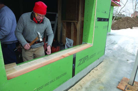 Pieces of beveled siding extending from the dam to the edge of the opening formed a sloped drainage plane.