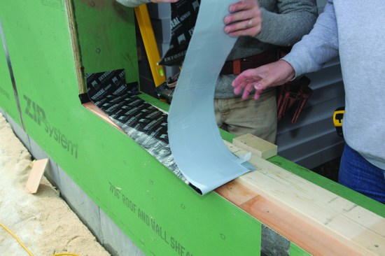 The folded flashing tape was lined up with a centerline previously marked on the dam.