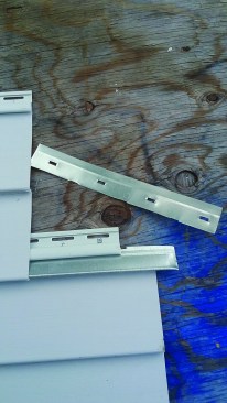 There are two different ways to reconnect separated panels. The first method is cutting a strip off a metal starter strip and inserting it into the lower locking strip to engage the separated panel at a lower level.