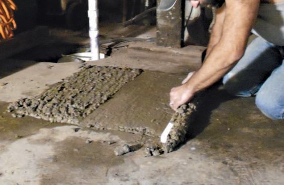 After the mix sets for few minutes, I screed the surface flat with a straightedge, let the water rise, and broom it off. After another few minutes, I lightly tap the surface with the straightedge, then screed it flush with the slab. In a few minutes I brush off any water that rises and let the concrete cure.