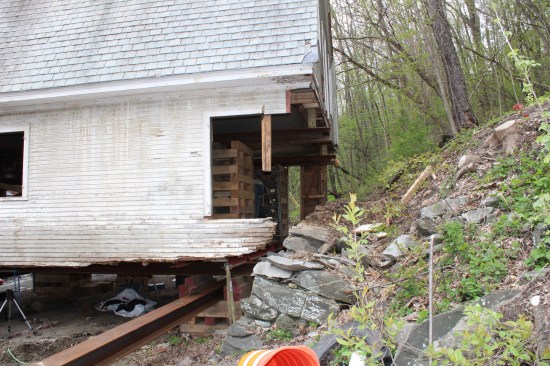The crew installed the first I-beam track into the north gable-end cribbing.