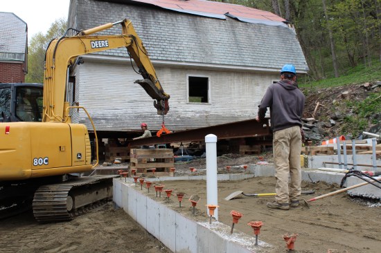 An excavator and a beam roller placed on midspan cribbing helped insert the south track.
