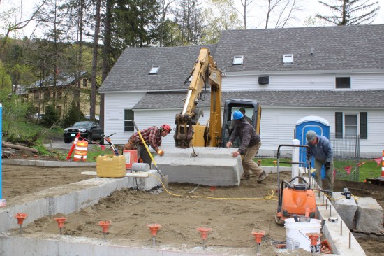 Waste-blocks rolled into place served as anchors for moving the building.