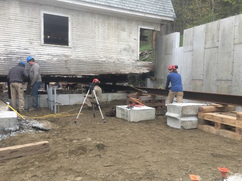 With the I-beam track set and leveled, the building was pulled with come-alongs anchored to the concrete waste-blocks.
