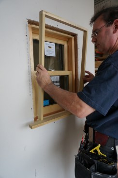 Using the reveal marks on the window frame, align the extension jamb assembly in the opening. 