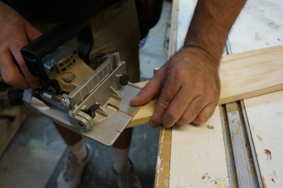 When cutting the slots for the biscuits, place the fence of the biscuit joiner on the flat back of the casing.