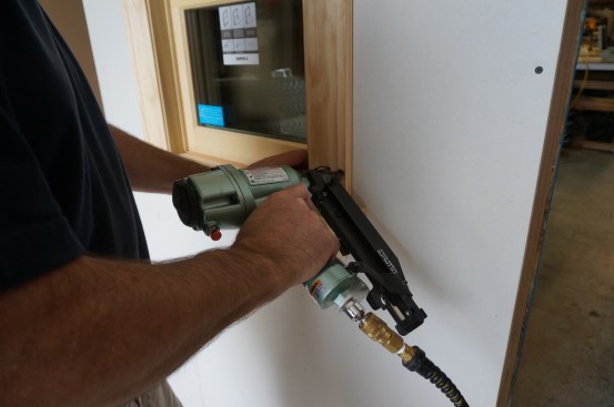 Larger 16-gauge finish nails attach the outside edge of the casing to the wall framing.