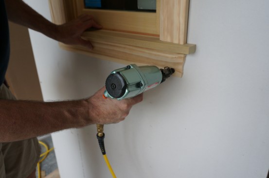 The final task for casing a window is nailing the apron in place. 16-gauge finish nails anchor the apron to the framing around the opening.
