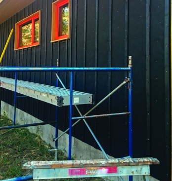 Open rainscreen systems leave the furring strips exposed in the gaps between the boards. Many different strategies can be employed to hide the natural color of the strips. One option is painting the strips before they go on.