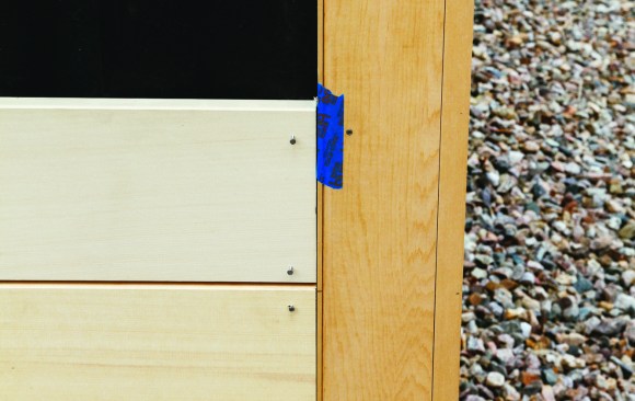 A temporary strip creates the open space at a corner board.