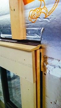 Furring strips end well above the head flashing over a window.