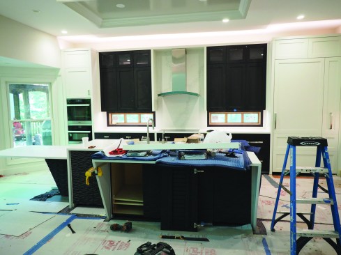 Uplighting was added above the cabinets to further disguise the discrepancy.