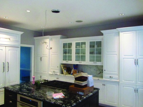 When cabinets end short of the ceiling, another strategy for hiding an out-of-level ceiling is varying the topography of the cabinets—using some cabinets that are deeper and some that are shorter than others.