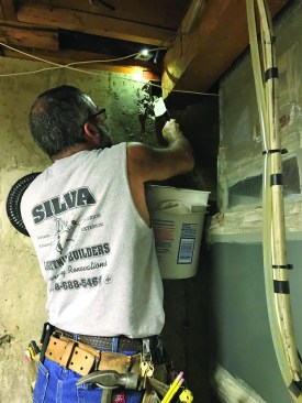 Next, the author replaced the parging around the girder with small stones and Type N mortar. The mortar filled in the pocket beside the girder to help prevent it from rolling or twisting under load.
