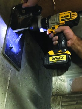 Next, he drilled the proper-size holes for concrete wedge anchors in the existing concrete foundation.