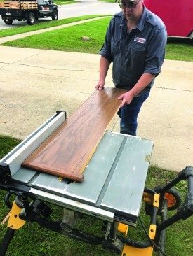 After prefinishing the tread stock off-site to minimize mess and smell, he rips the stock to the correct width for the stairway, including a 1 1/4-inch overhang.
