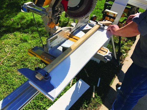 At the saw, he places the template on the riser stock and transfers the template layout.