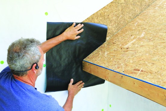 Subfascia or solid blocking provides backing for the flashing layers. A square of WRB (black was used in the photos for clarity) slides behind the eaves-wall intersection.