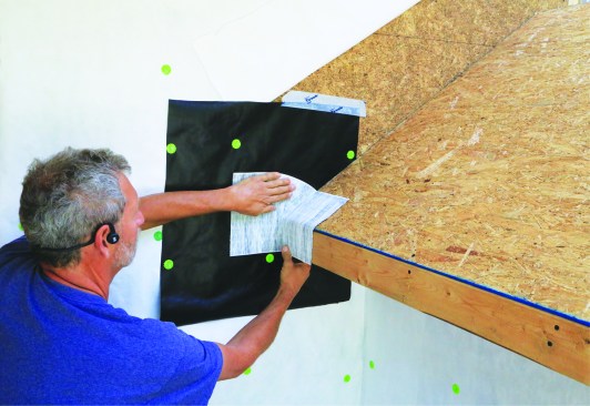 Flexible flashing tape bridges the intersecting surfaces.