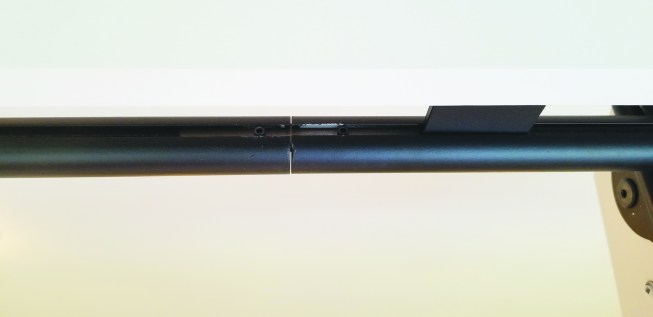 The cylindrical track came in sections that were cut to fit the built-in shelves. Brackets slide into the track on the first side and attach to the shelves. The ladder then slides onto the track.