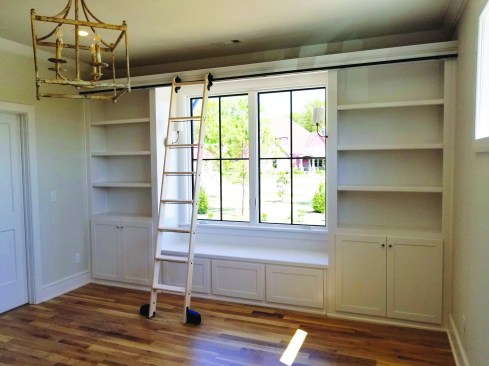 After inserting the splice hardware into the track (16), the second section attaches to the first, installed in similar fashion. The finished ladder is handsome and useful for accessing the bookshelves.