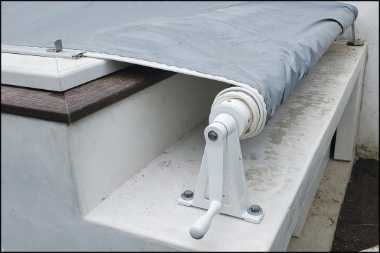 Figure 14. The hand crank for the manually operated security pool cover was mounted to the mechanical equipment housing. The cover slides in tracks located on each side of the pool and is strong enough to allow a person to walk on it without falling through.