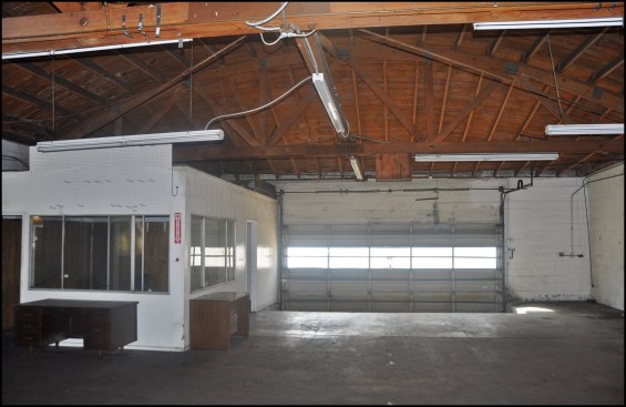 Existing bowstring trusses and 2-by rafters in the open garage portion of the building.