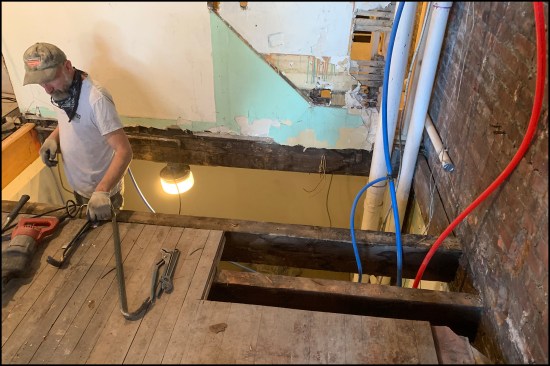 Project manager, Danny DoCouto, preps the framed opening for the new winder staircase.