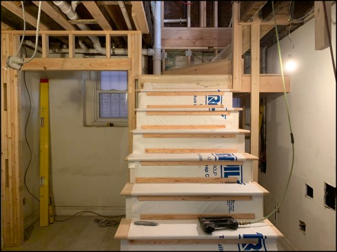 The stair structure ties in with closets at left and right—essential to the client’s demands.