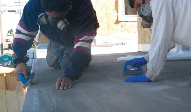 Once the cement has set, the crew uses mason’s stones to grind off any high spots and lap marks in the finish.
