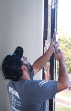 I then apply a generous bead of caulk to the back edges of the casing and to the sill.