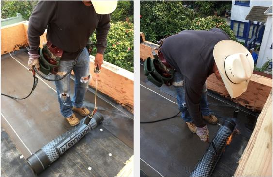 Applying the torch-down membrane.