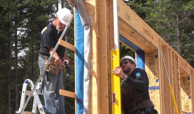 Precisely plumbing each wall panel is a critical step in setting the building, because the floor panels for the structure are already built, and can’t be modified to fit a wall that is not perfectly set in place. So the crew carefully dials in each wall panel by twisting the adjustable brace until it’s perfectly plumb.