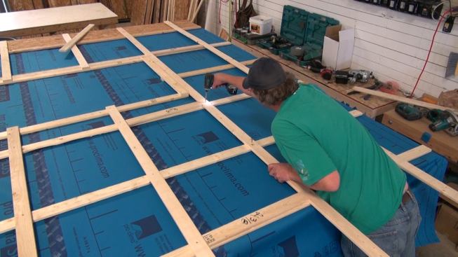 Two layers of strapping are screwed down in a crisscross pattern over the fabric-covered wood I-joist outer wall frame. This strapping provides nailing for wood siding, and creates a drainage plane and convection space so that the wall exterior is able to drain and dry if any incidental moisture gets behind the siding.