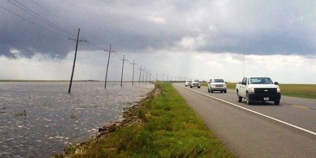 Stretches of the road connecting the mainland with critical oil-industry facilities in Fourchon, La., run level with the rising ocean.