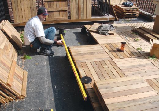 Pedestal supports and preassembled wood tiles simplified installation and maintenance of this rooftop deck.