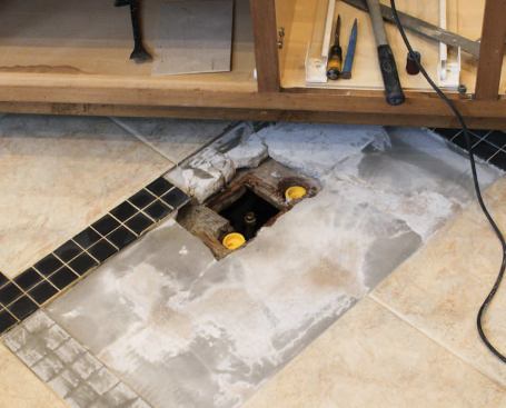 With the plumbing repairs complete, we covered the hole in the subfloor.
