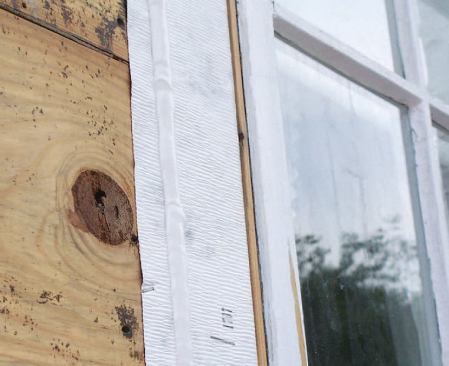To help make a continuous air barrier, the rigid foam was glued to the flashing tape at the jambs.