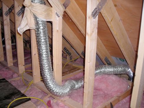 Fiberglass insulation, because it had been loosely laid over the bath fans, did not contact the drywall. Not only did this insulate poorly, but it allowed cold winter air to reach the ceiling board.